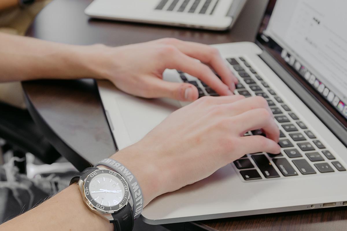 computer science student types on a keyboard.