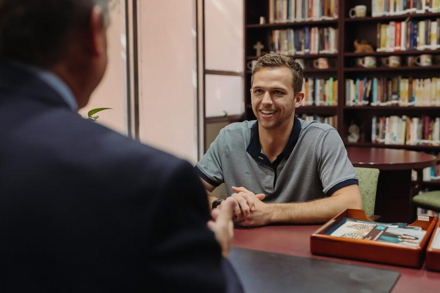 PBA student engages in discussion with an instructor.